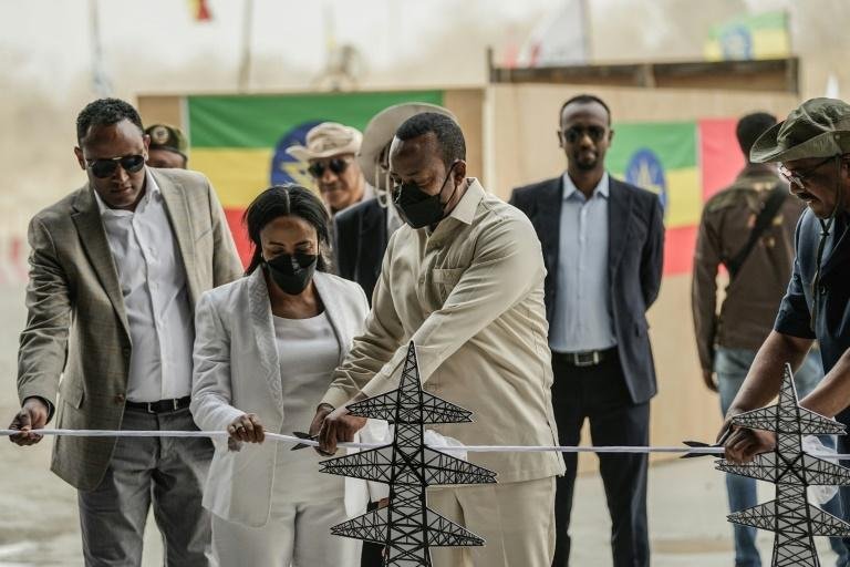 Ethiopia Prime Minister Abiy Ahmed cuts a ribbon to mark the commissioning of the dam