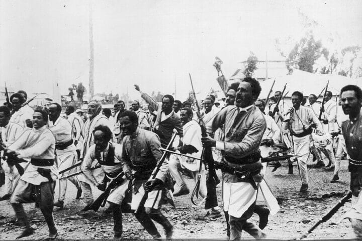 The powerful image—public domain from Wikimedia Commons—shows Ethiopian troops en route to the northern front, just weeks after Italy’s invasion began in October 1935.